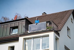 Gewinnerin des Balkonsolaranlagen-Wettbewerbs auf ihrem Balkon.